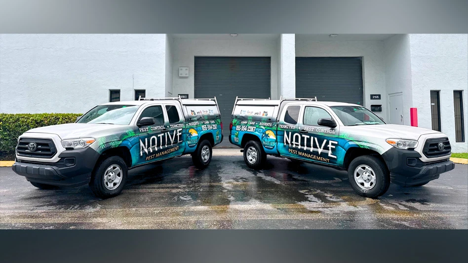Photo of two Native Pest Management trucks.