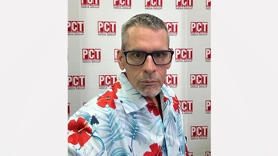 David Poplin in front of the PCT booth at PestWorld 2023 in Hawaii.